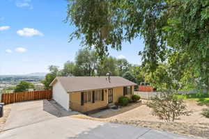 Single story home featuring brick siding, a shingled roof, and concrete driveway