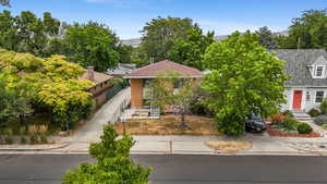 View of front facade with a fenced front yard, a shingled roof, and a mountain view