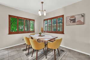 Dining room featuring tile patterned flooring and a chandelier