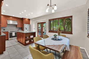Dining space featuring recessed lighting, a chandelier, and light tile patterned floors