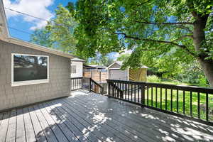 Deck featuring a shed and a yard