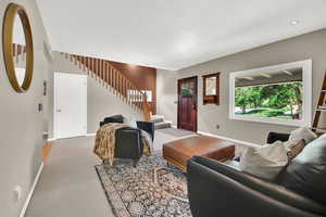 Living room featuring stairway, carpet floors, and recessed lighting