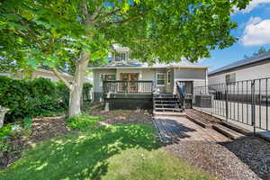 View of front of home with a wooden deck and french doors