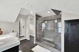 Full bath featuring a shower stall, tile patterned floors, vanity, recessed lighting, and a textured ceiling