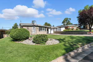 View of front of home with brick siding and a carport