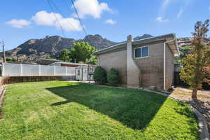 Fenced backyard with a shed and a mountain view