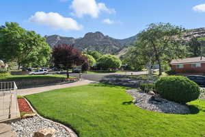 View of green lawn featuring a mountain view