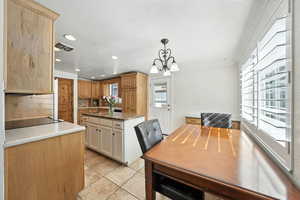 Dining room with a chandelier, recessed lighting, light tile patterned flooring, and ornamental molding