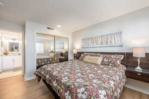 Bedroom with light wood-style floors and a closet