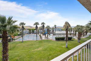 View of home's community with a tennis court