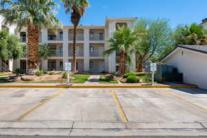 View of property with uncovered parking