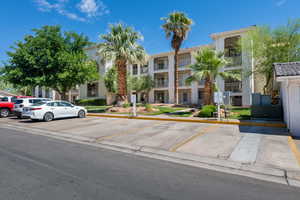 View of front of property with stucco siding and uncovered parking