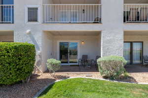 Back of house with stucco siding, a patio, and a balcony