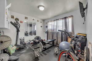 Workout room featuring a textured ceiling