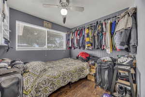 Bedroom featuring wood finished floors and a ceiling fan