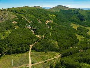 View of property location with a mountainous background and property boundaries highlighted
