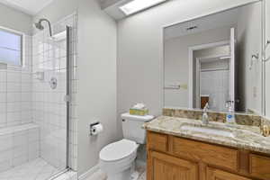 Bathroom featuring a stall shower and vanity