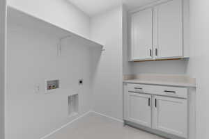 Laundry area with cabinet space, electric dryer hookup, and washer hookup