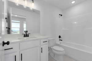 Full bathroom with vanity, washtub / shower combination, tile patterned floors, and recessed lighting