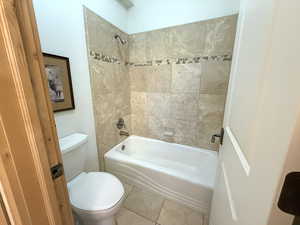 Full bath with bathtub / shower combination and tile patterned floors