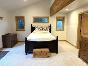 Bedroom featuring light colored carpet, vaulted ceiling, and recessed lighting
