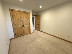 Unfurnished bedroom with recessed lighting and carpet flooring