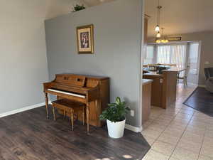 Sitting room with dark wood-style floors and a chandelier