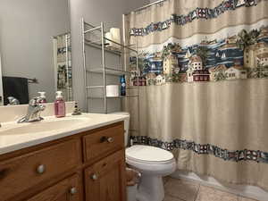 Full bathroom with tile patterned floors and vanity