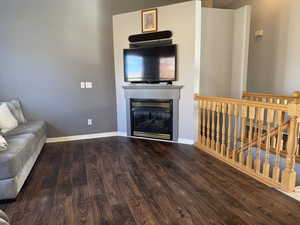 Living area with wood finished floors and a glass covered fireplace
