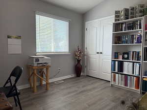 Home office with wood finished floors and baseboards