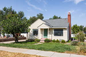 Bungalow-style house with a chimney and a shingled roof