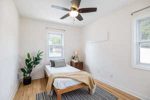 Bedroom with light wood finished floors and a ceiling fan