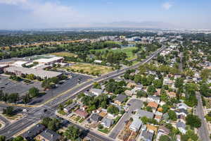 Aerial view of property and surrounding area featuring a mountainous background