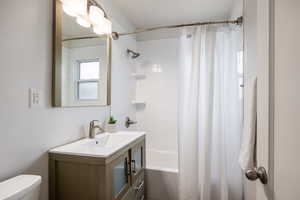 Bathroom featuring shower / tub combo and vanity