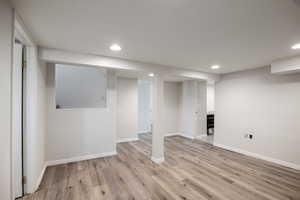 Finished basement featuring recessed lighting and light wood-style flooring