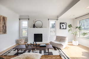 Living room with wood finished floors and a fireplace