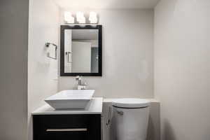 Half bathroom featuring toilet and vanity
