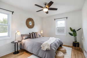 Bedroom featuring light wood-style floors and a ceiling fan