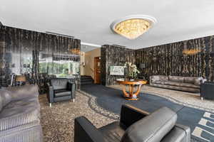 Carpeted living room featuring a chandelier