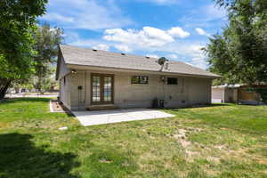 Back of house with french doors, roof with shingles, a patio, and brick siding