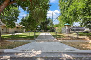 View of community with a playground and a gate