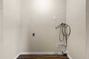 Laundry room featuring hookup for a washing machine, wood finished floors, and electric dryer hookup