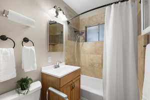 Full bathroom featuring shower / tub combo and vanity