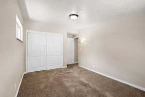 Unfurnished bedroom with carpet floors and a closet