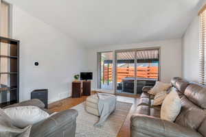 Living room featuring lofted ceiling and a textured ceiling