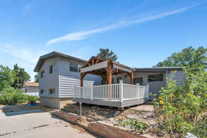 Rear view of property featuring a deck