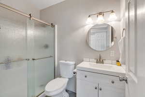 Bathroom featuring vanity and a shower stall