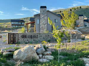 Community sign with a mountain view