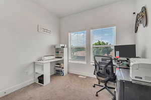 Office with baseboards and carpet floors