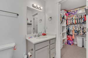 Bathroom featuring vanity and a closet